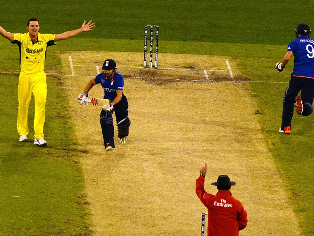 Umpire Aleem Dar (bottom) raises his finger to give England's batsman James Taylor (L) out lbw out as James Anderson (R) fails to gain his ground and later declared run out during the Pool A 2015 Cricket World Cup match between Australia and England at th