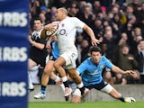 England's centre Jonathan Joseph slips a tackle to run in and score England's second try during the Six Nations international rugby union match between England and Italy at Twickenham Stadium in south west London on February 14, 2015