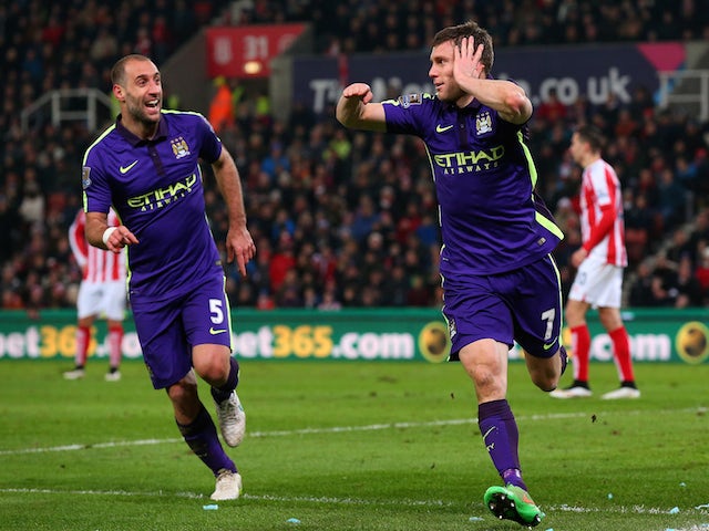 James Milner of Manchester City celebrates with team-mate Pablo Zabaleta after scoring his team's second goal during the Barclays Premier League match against Stoke on February 11, 2015