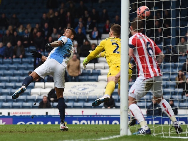 Blackburn striker Joshua King (L) scores their first goal during the English FA Cup fifth round football match against Stoke City on February 14, 2015