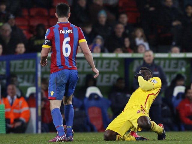 Liverpool's English Italian striker Mario Balotelli reacts after a tackle by Crystal Palace's English defender Scott Dann during the English FA Cup fifth round football match between Crystal Palace and Liverpool at Selhurst Park in south London on Februar