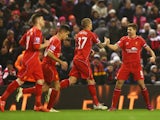 Steven Gerrard of Liverpool celebrates scoring his penalty with team mates during the Barclays Premier League match between Liverpool and Tottenham Hotspur at Anfield on February 10, 2015 