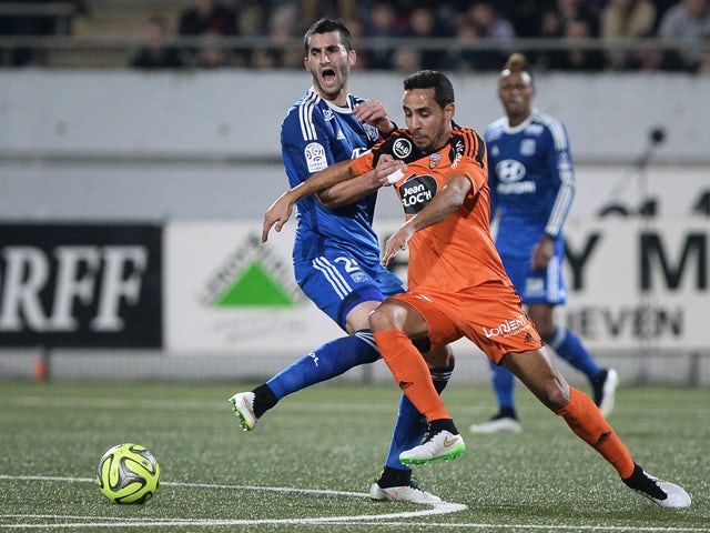 Lorient's French-Algerian midfielder Walid Mesloub vies for the ball with Lyon's French midfielder Maxime Gonalons during the French L1 football match between Lorient (FCL) and Lyon (OL) on February 15, 2015