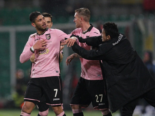 Palermo's Achraf Lazaar celebrates with teammates after scoring during the Italian Serie A football match Palermo vs Napoli on February 14, 2015