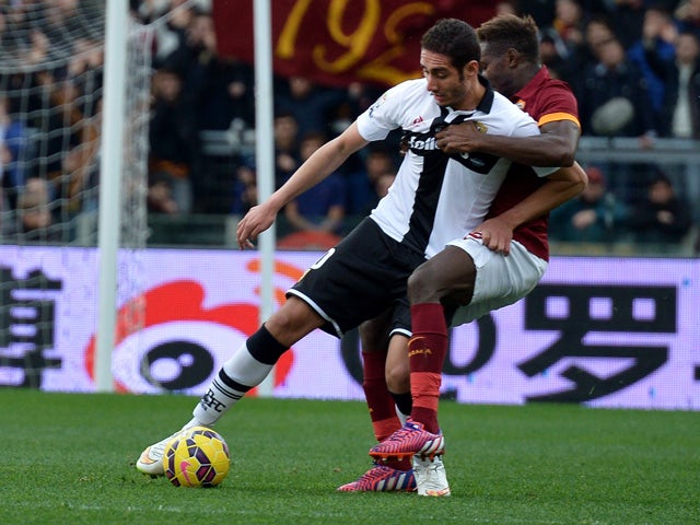 Parma's forward from Algeria Ishak Belfodil fights for the ball with Roma's defender from France Mapou Yanga-Mbiwa during the Italian Serie A football match AS Roma vs Parma at the Olympic stadium in Rome on February 15, 2015
