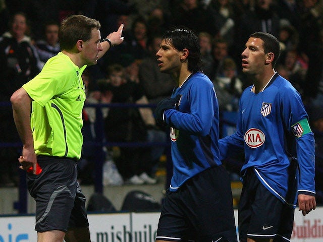 Referee N Vollquartz shows a red card to Sergio Aguero of Atletico Madrid during the UEFA Cup Round of 32, First Leg match against Bolton on February 14, 2008