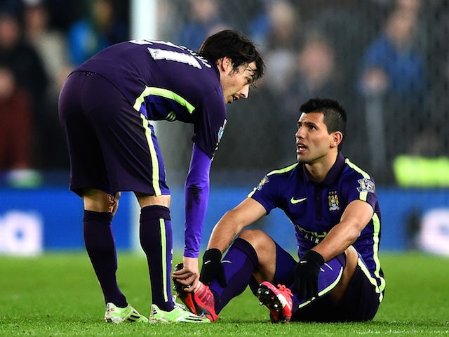 Sergio Aguero of Manchester City speaks with team-mate David Silva after picking up an injury during the Barclays Premier League match against Stoke on February 11, 2015