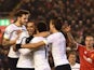 Tottenham Hotspur's Belgian midfielder Mousa Dembele is surrounded by team-mates after scoring their second goal to equalise 2-2 during the English Premier League football match between Liverpool and Tottenham Hotspur at the Anfield stadium in Liverpool, 