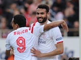 Sevilla's midfielder Vicente Iborra (C) celebrates with Sevilla's Colombian forward Carlos Bacca (L) after scoring during the Spanish league football match against Cordoba on February 14, 2015