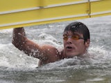 Vladimir Dyatchin of Russia crosses the line to win silver in the Men's Open Water 25km during Day Eight of the 14th FINA World Championships at the Jinshan City Beach on July 23, 2011