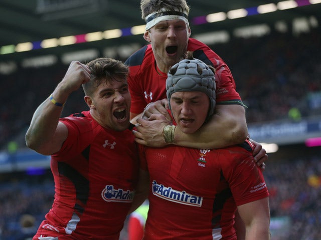 Wales's centre Jonathan Davies celebrates scoring a try with Wales's scrum half Rhys Webb during the Six Nations international rugby union match between Scotland and Wales at Murrayfield in Edinburgh on February 15, 2015