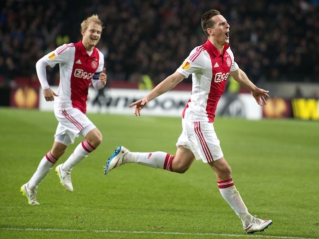 Ajax Amsterdam player Arek Milik (R) celebrates his 1-0 score with team player Nicolai Boilesen (L) during their Europa League round of 32 football match against Legia on February 19, 2015
