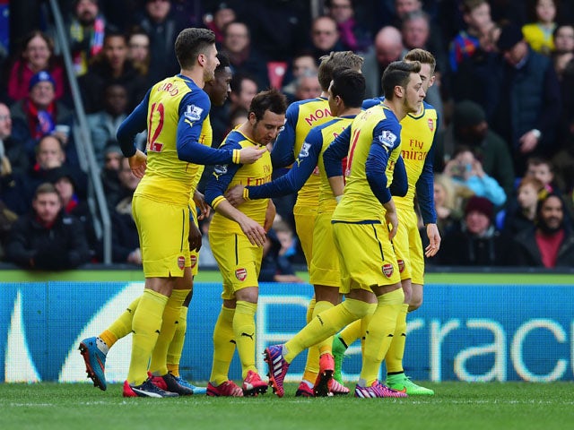 Santi Cazorla of Arsenal celebrates with team mates as he scores their first goal from a penalty during the Barclays Premier League match between Crystal Palace and Arsenal at Selhurst Park on February 21, 2015