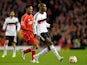 Atiba Hutchinson of Besiktas passes the ball as Daniel Sturridge of Liverpool closes in during the UEFA Europa League Round of 32 match on February 19, 2015