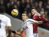 Erik Lamela of Spurs and West Ham's Carl Jenkinson tussle for the ball on February 22, 2015
