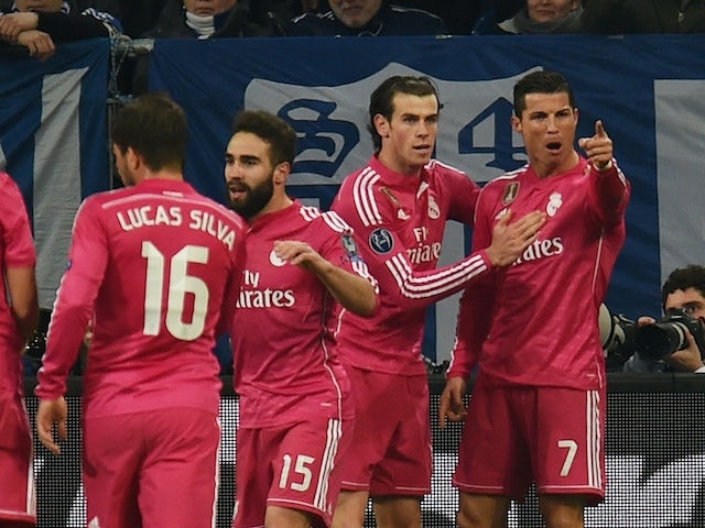 Real Madrid's Portuguese forward Cristiano Ronaldo (R) celebrates with teammates after scoring during the last sixteen, first-leg UEFA Champions League football match against Schalke on February 18, 2015