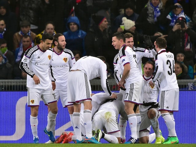 Basel teammates celebrate after Paraguayan midfielder Derlis Gonzalez (Hidden) opened the scoring during the UEFA Champions League round of 16 first leg football match against Porto on February 18, 2015