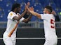 Gervinho (L) with his teammate Daniele Verde of AS Roma celebrates after scoring the opening goal during the UEFA Europa League Round of 32 match against Feyenoord on February 19, 2015