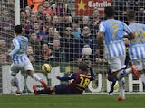 Malaga's Argentinian midfielder Pablo Javier Perez scores a goal during the Spanish league football match FC Barcelona vs Malaga CF at the Camp Nou stadium in Barcelona on February 21, 2015