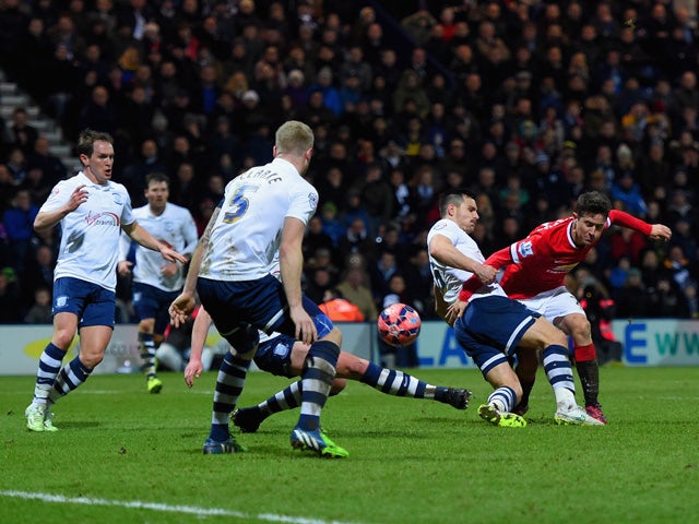 Ander Herrera of Manchester United scores their first goal under pressure from Bailey Wright of Preston North End during the FA Cup Fifth round match between Preston North End and Manchester United at Deepdale on February 16, 2015