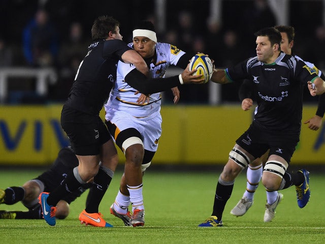 Nathan Hughes of Wasps is tackled by Adam Powell of Newcastle Falcons during the Aviva Premiership match between Newcastle Falcons and Wasps at Kingston Park on February 20, 2015