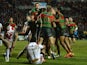 Luke Keary of South Sydney Rabbitohs (obscured) is mobbed by team mates after scoring their fifth tryduring the World Club Challenge match against St Helens on February 22, 2015