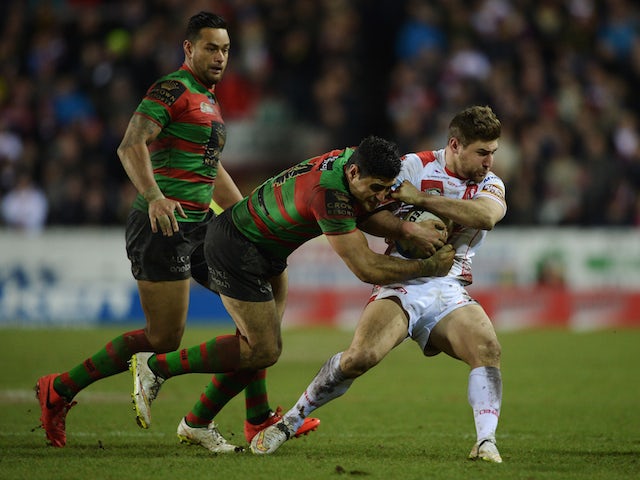 Tom Makinson of St Helens is tackled by Bryson Goodwin of South Sydney Rabbitohs during the World Club Challenge match on February 22, 2015