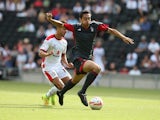 Tyler Walker of Nottingham Forest attempts to move forward with the ball away from George Baldock of MK Dons during the Pre-Season Friendly between MK Dons and Nottingham Forest at Stadium mk on July 27, 2014
