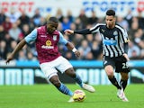 Jores Okore of Aston Villa and Emmanuel Riviere of Newcastle United battle for the ball during the Barclays Premier League match between Newcastle United and Aston Villa at St James' Park on February 28, 2015