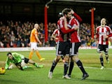 Jon Toral of Brentford is congratulated by teammate Jonathan Douglas of Brentford after scoring the opening goal during the Sky Bet Championship match between Brentford and Blackpool at Griffin Park on February 24, 2015