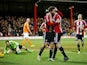 Jon Toral of Brentford is congratulated by teammate Jonathan Douglas of Brentford after scoring the opening goal during the Sky Bet Championship match between Brentford and Blackpool at Griffin Park on February 24, 2015