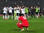 Liverpool's Dejan Lovren reacts after missing the last penalty while Besiktas' players celebrate during the UEFA Europa League round of 32 second-leg football match Besiktas  on February 26, 2015