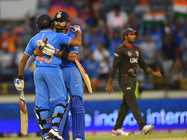 India's Rohit Sharma embraces teammate Virat Kohli after their win during the 2015 Cricket World Cup Pool B match between the UAE and India in Perth on February 28, 2015