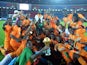 Ivory Coast's players celebrate with the trophy at the end of the 2015 African Cup of Nations final football match between Ivory Coast and Ghana in Bata on February 8, 2015