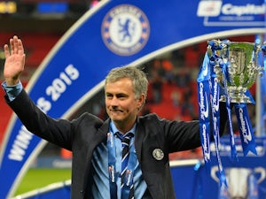 Chelsea's Portuguese manager Jose Mourinho celebrates with the trophy during the presentation after Chelsea won the League Cup final football match against Tottenham Hotspur at Wembley Stadium on March 1, 2015