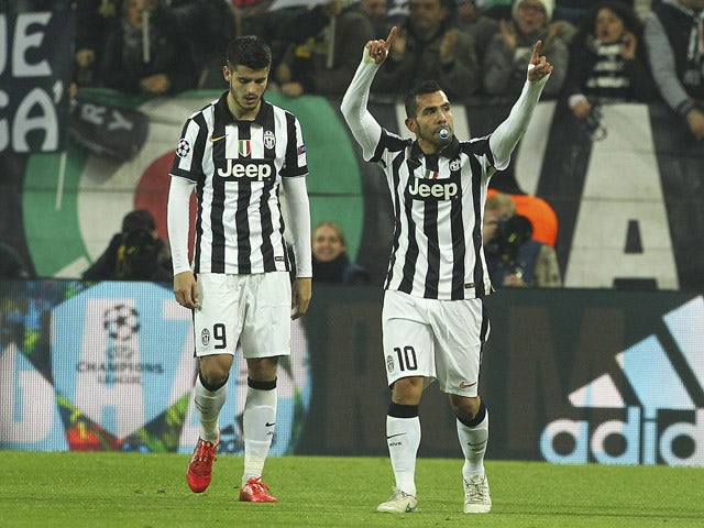 Carlos Tevez of Juventus FC celebrates after scoring the opening goal during the UEFA Champions League Round of 16 match between Juventus and Borussia Dortmund at Juventus Arena on February 24, 2015