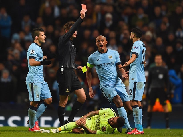 Vincent Kompany of Manchester City appeals as Referee Dr. Felix Brych shows Gael Clichy of Manchester City a red card during the UEFA Champions League Round of 16 match between Manchester City and Barcelona at Etihad Stadium on February 24, 2015