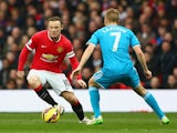 Wayne Rooney of Manchester United is closed down by Sebastian Larsson of Sunderland during the Barclays Premier League match between Manchester United and Sunderland at Old Trafford on February 28, 2015