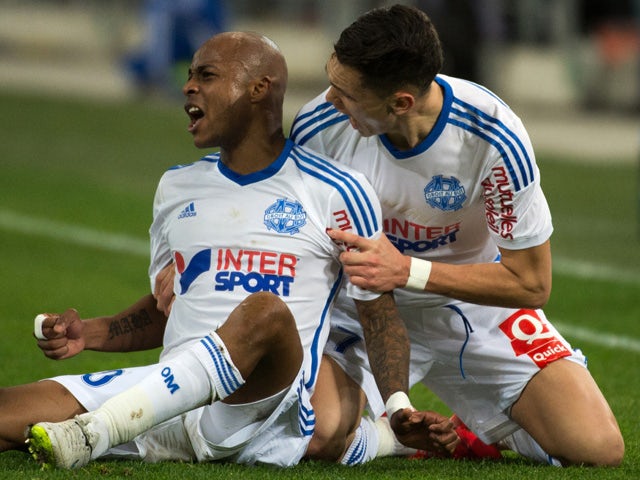 Marseille's Ghanaian forward Andre Ayew celebrates with a teammate after scoring a goal during the French L1 football match between Marseille (OM) and Caen (SMC) on February 27, 2015