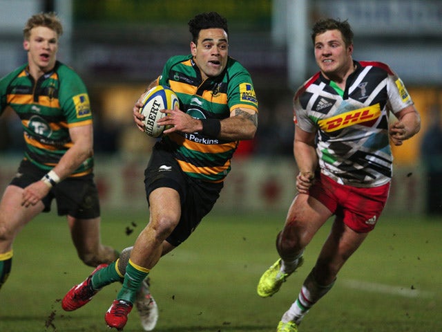 Kahn Fotuali'i of Northampton Saints breaks away from Harry Sloan of Harlequins during the Aviva Premiership match between Northampton Saints and Harlequins at Franklin's Gardens on February 27, 2015