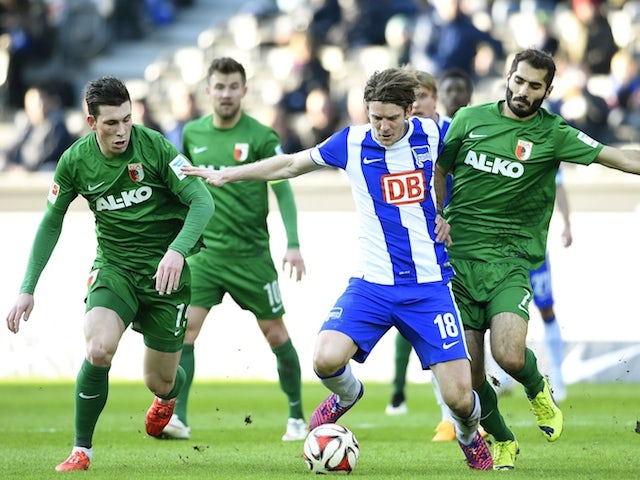 Hertha's Peter Niemeyer battles with Augsburg's Pierre Emile Hoejbjerg and Halil Altintop during in the Bundesliga match on February 28, 2015