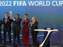Qatar's Emir Sheikh Hamad bin Khalifa al-Thani (C) raises the World Cup trophy as he stands with FIFA president Sepp Blatter (R) after Qatar was chosen to host the 2022 World Cup at the FIFA headquarters in Zurich on December 2, 2010