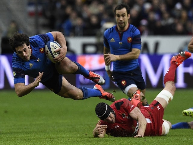 France's centre Remi Lamerat falls after being tackled during the Six Nations international rugby union match between France and Wales on February 28, 2015