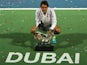 Roger Federer of Switzerland poses with the ATP Dubai Duty Free Tennis Championships trophy after defeating World number one Novak Djokovic of Serbia during their final on February 28, 2015