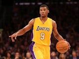 Ronnie Price #9 the Los Angeles Lakers brings the ball up on offense against Stephen Curry #30 of the Golden State Warriors at Staples Center on December 23, 2014