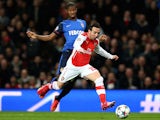 Santi Cazorla of Arsenal is challenged by Almary Toure of Monaco during the UEFA Champions League round of 16, first leg match  on February 25, 2015
