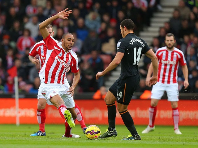 Steven N'Zonzi of Stoke City competes with Jake Livermore of Hull City during the Barclays Premier League match between Stoke City and Hull City at Britannia Stadium on February 28, 2015