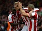 Peter Crouch of Stoke City celebrates scoring the first goal with team-mates Victor Moses and Jonathan Walters during the Barclays Premier League match between Stoke City and Hull City at Britannia Stadium on February 28, 2015
