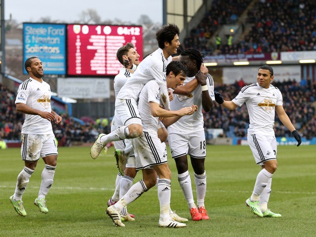 Jack Cork of Swansea City is congratulated by teamates after his shot is deflected for an own goal during the Barclays Premier League match between Burnley and Swansea City at Turf Moor on February 28, 2015
