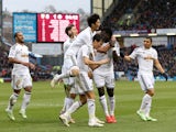 Jack Cork of Swansea City is congratulated by teamates after his shot is deflected for an own goal during the Barclays Premier League match between Burnley and Swansea City at Turf Moor on February 28, 2015